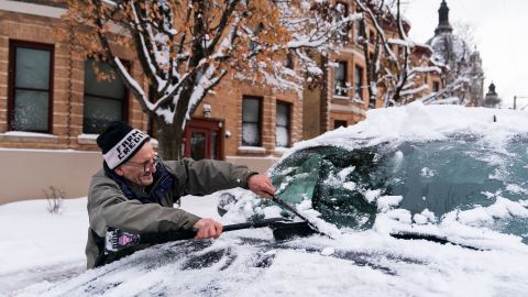 Patrick Costanzo brushes snow off a friend's car  in St. Paul, Minnesota.