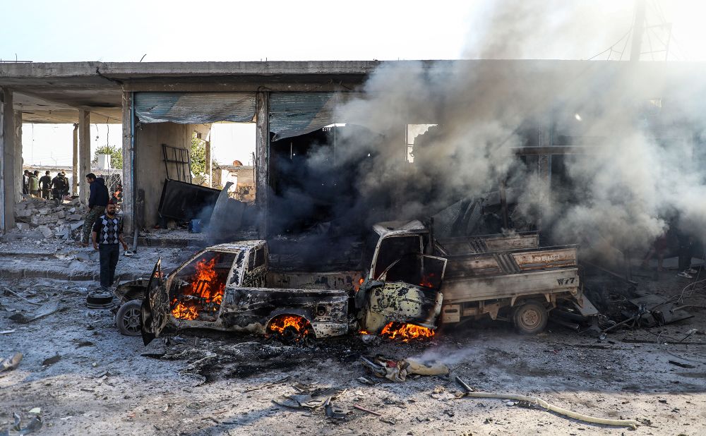 A car burns following a car bomb explosion in Tal Abyad, a city in northern Syria near the Turkey border, on Saturday, November 23.