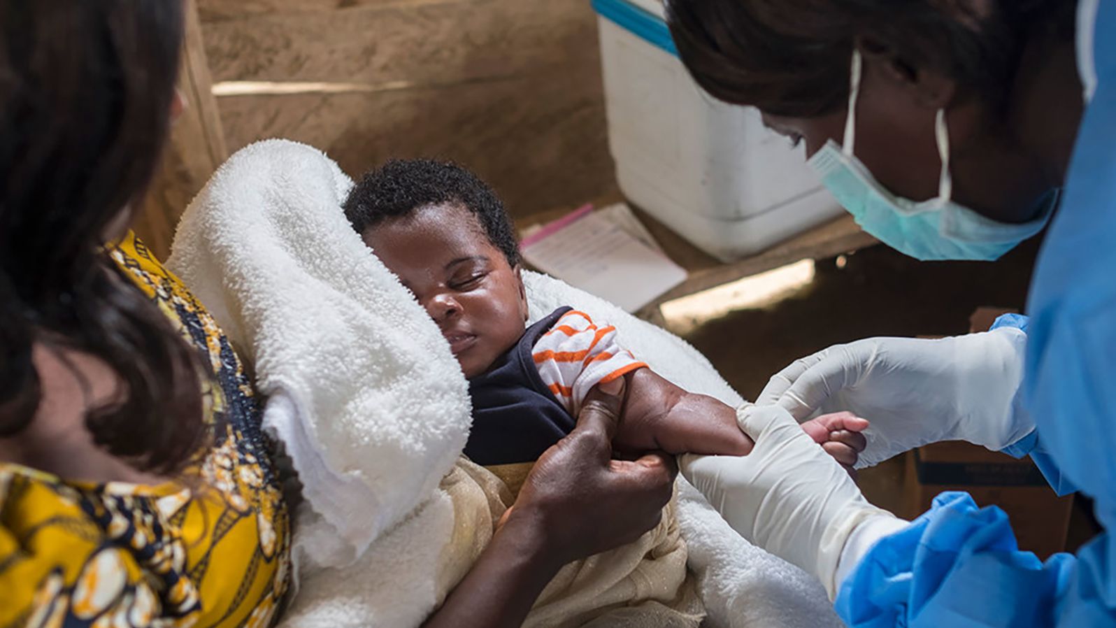 A nurse prepares to vaccinate an infant in North Kivu province, Democratic Republic of  Congo.