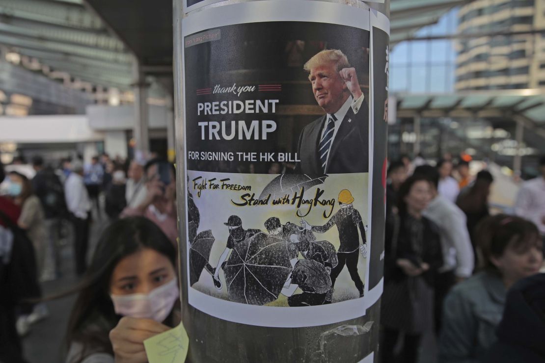 Protesters stick a poster featuring US President Donald Trump on a pillar during a demonstration in Central, the financial district of Hong Kong.