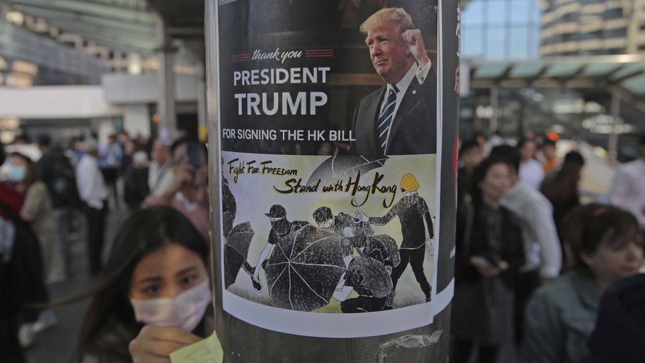 Protesters stick a poster featuring US President Donald Trump on a pillar during a demonstration in Central, the financial district of Hong Kong.