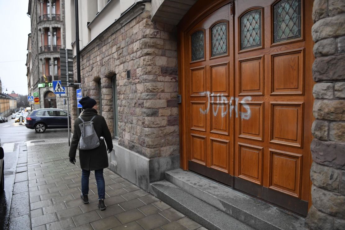 A woman walks past Swedish football player Zlatan Ibrahimovic's property in Stockholm, where someone sprayed "Judas" on the the door.