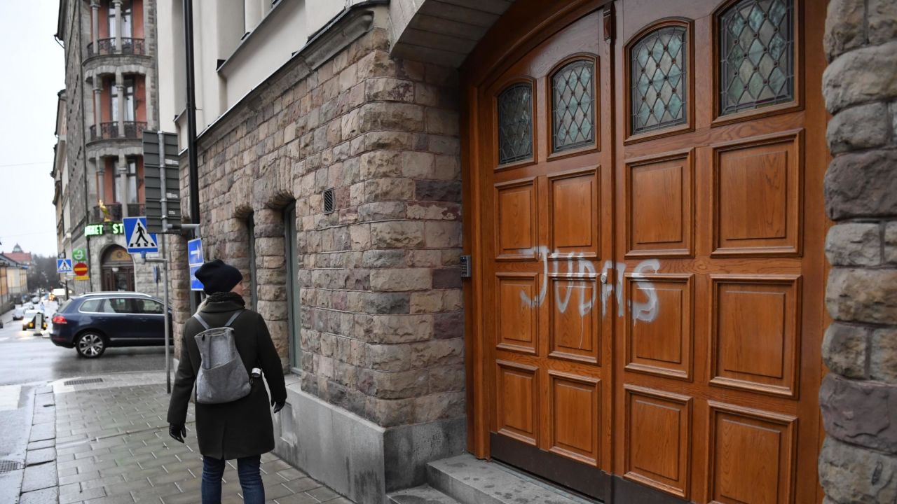 A woman walks past Swedish football player Zlatan Ibrahimovic's property in Stockholm, where someone sprayed "Judas" on the the door.