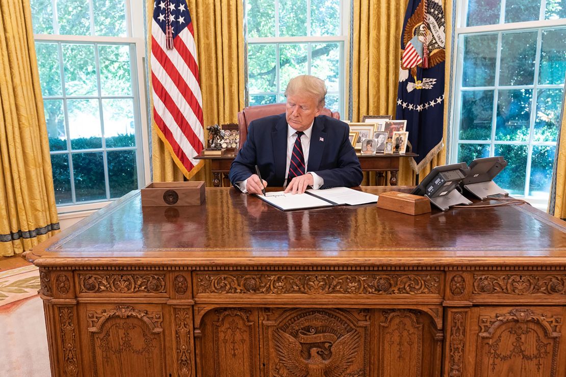 In this White House photo, President Donald Trump signs an executive order on September 19, 2019 to modernize the flu vaccine.