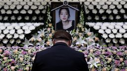 A South Korean man pays tribute at a memorial altar as his makes a call of condolence in honor of the K-pop star Goo Hara at the Seoul St. Mary's Hospital on November 25, 2019 in Seoul, South Korea. K-pop star Goo Hara of Kara was found dead yesterday on November 24.