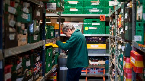A volunteer at a Trussell Trust food bank sorts out the stock.