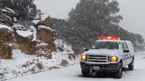 This photo tweeted by the Santa Barbara County Fire Department shows a Santa Barbara Fire Department truck along E. Camino Cielo as snow falls at the 3,500 foot level on the fire footprint in Santa Barbara, California, on Thursday, November 28, 2019