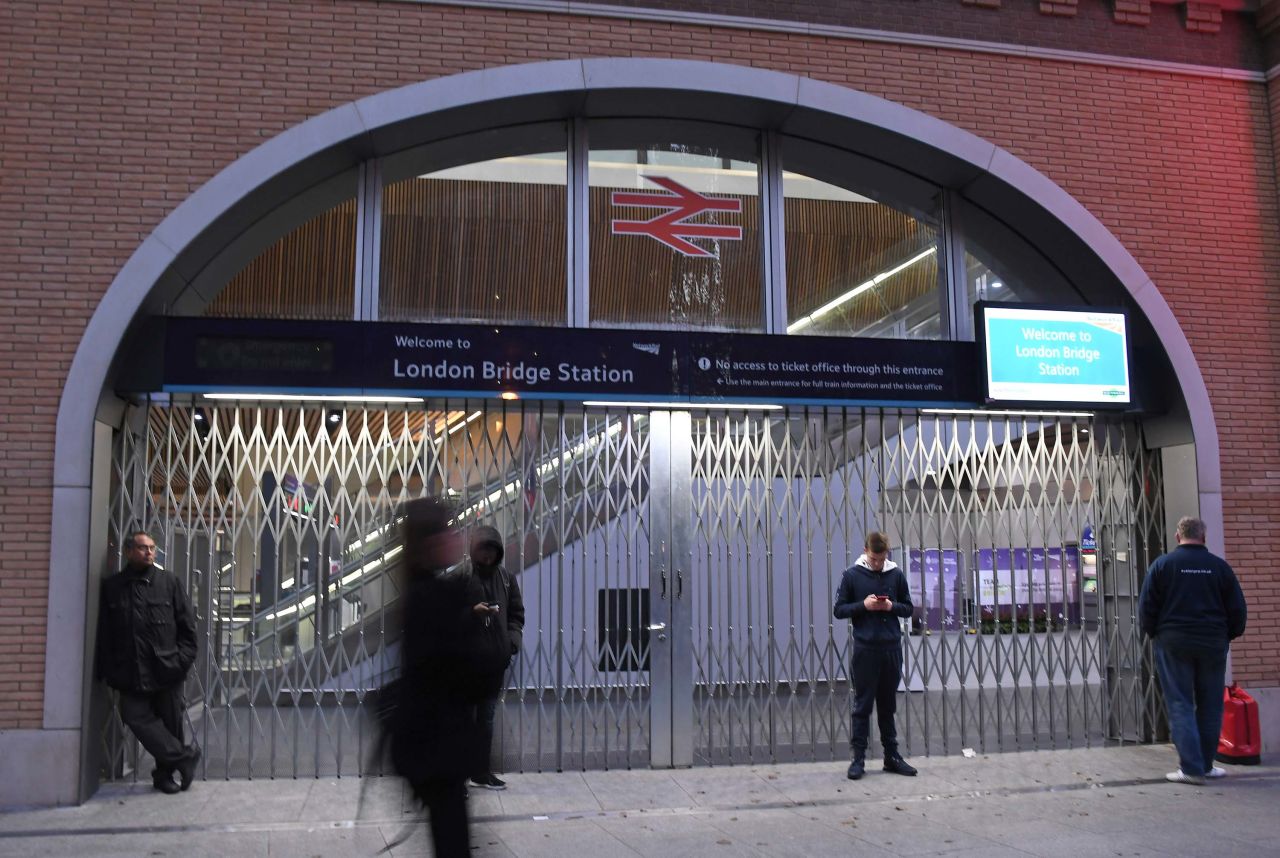 People stand outside the London Bridge Station after it was closed.
