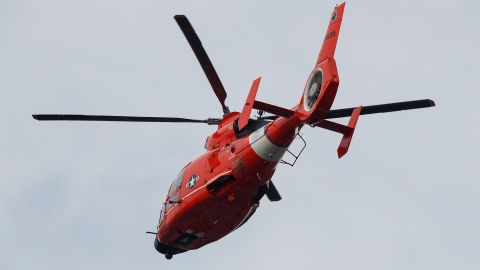 A Coast Guard MH-65D Dolphin helicopter like this one deployed in the search.