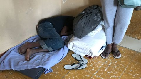 A migrant mother and her child have claimed this corner at one of Ortiz's shelters along the border.