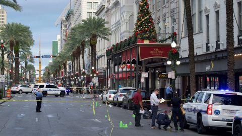 New Orleans police investigate the shooting scene Sunday.
