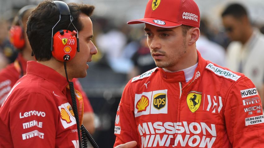 Ferrari's Monegasque driver Charles Leclerc (R) chats with an engineer on the grid at the Yas Marina Circuit in Abu Dhabi, ahead of the final race of the season, on December 1, 2019. (Photo by ANDREJ ISAKOVIC / AFP) (Photo by ANDREJ ISAKOVIC/AFP via Getty Images)