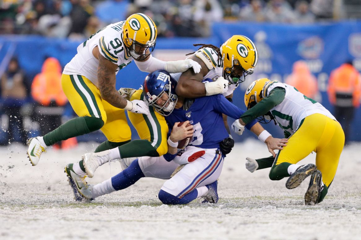 New York Giants quarterback Daniel Jones is sacked by Green Bay Packers defenders during the second half of an NFL football game in East Rutherford, New Jersey, on December 1.