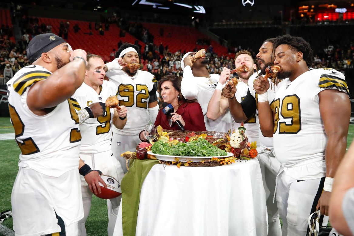Members of the New Orleans Saints celebrate their victory with turkey legs following an NFL game against the Atlanta Falcons at Mercedes-Benz Stadium in Atlanta on November 28.