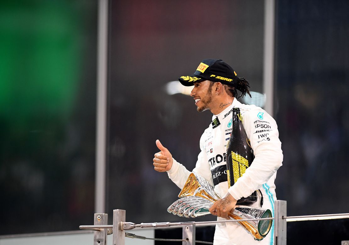 Hamilton celebrates on the podium after the Abu Dhabi Grand Prix.