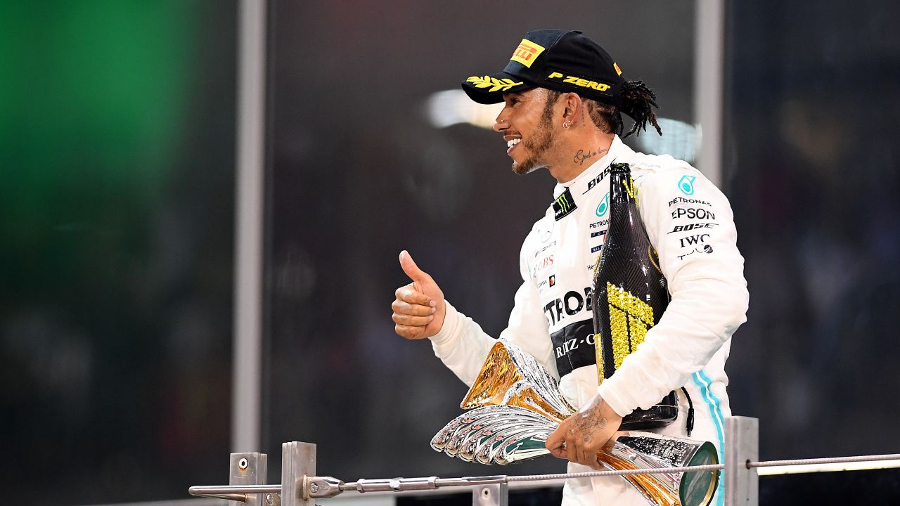 Hamilton celebrates on the podium after the Abu Dhabi Grand Prix.