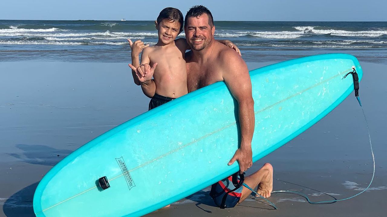 Chandler Moore and his dad, Shaun, at the beach on Saturday after the shark encounter.