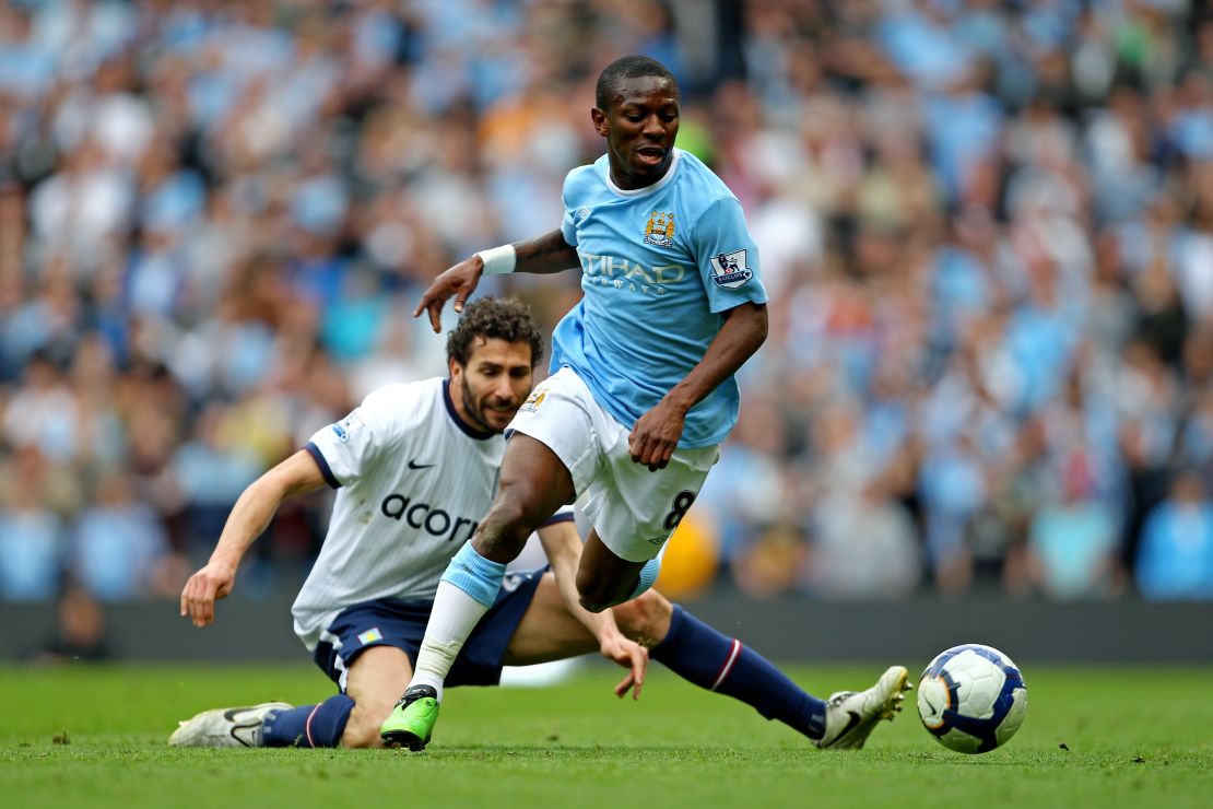 Wright-Phillips goes past the tackle from Carlos Cuellar of Aston Villa.