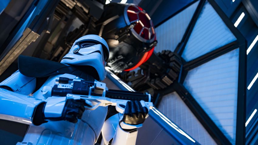 A First Order Stormtrooper stands guard in a Star Destroyer hangar bay beneath a docked TIE fighter in Star Wars: Rise of the Resistance, the groundbreaking new attraction opening Dec. 5, 2019, inside Star Wars: Galaxy's Edge at Disney's Hollywood Studios in Florida and Jan. 17, 2020, at Disneyland Park in California. Guests enter the hangar bay after their ship is caught in the Star Destroyer's tractor beam. (Matt Stroshane, photographer)