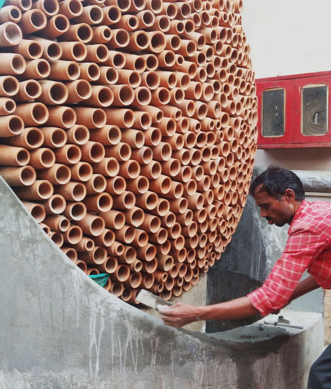 A beehive-like terracotta cooling structure being built in Noida, Uttar Pradesh.