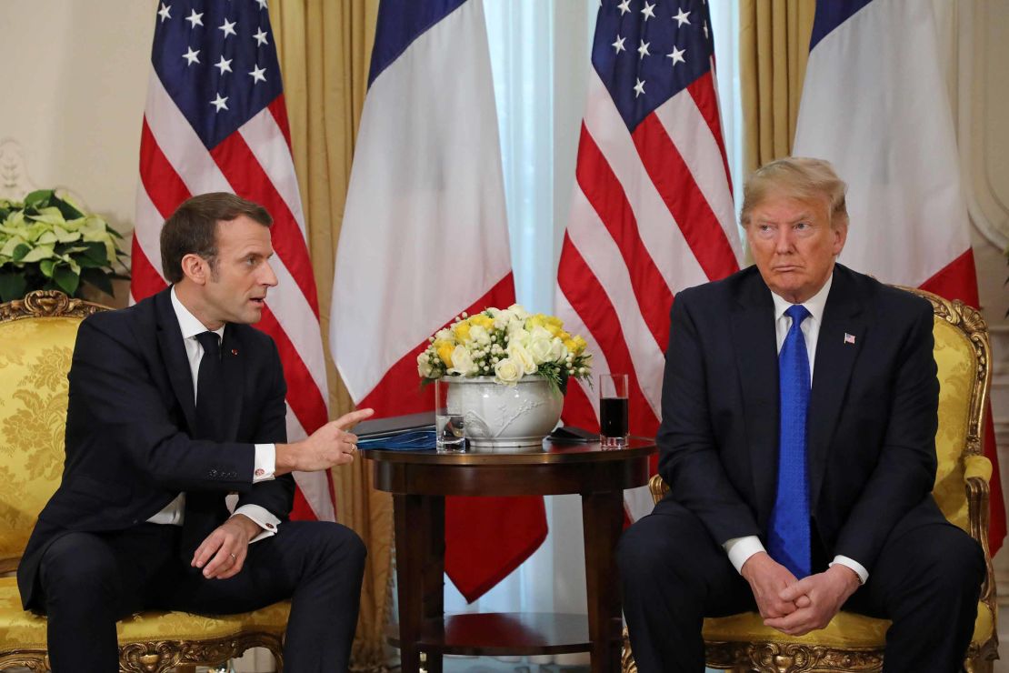 US President Donald Trump and France's President Emmanuel Macron react as they talk during their meeting at Winfield House, London, on Tuesday, December 3.