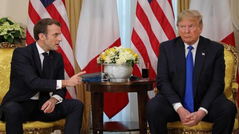 US President Donald Trump and France's President Emmanuel Macron react as they talk during their meeting at Winfield House, London, on Tuesday, December 3.
