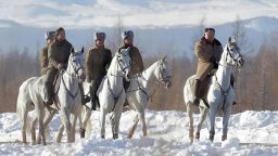 This undated picture released from North Korea's official Korean Central News Agency (KCNA) on December 4, 2019 shows North Korean leader Kim Jong Un (C) riding a horse as he visits battle sites at Mount Paektu, Ryanggang.
