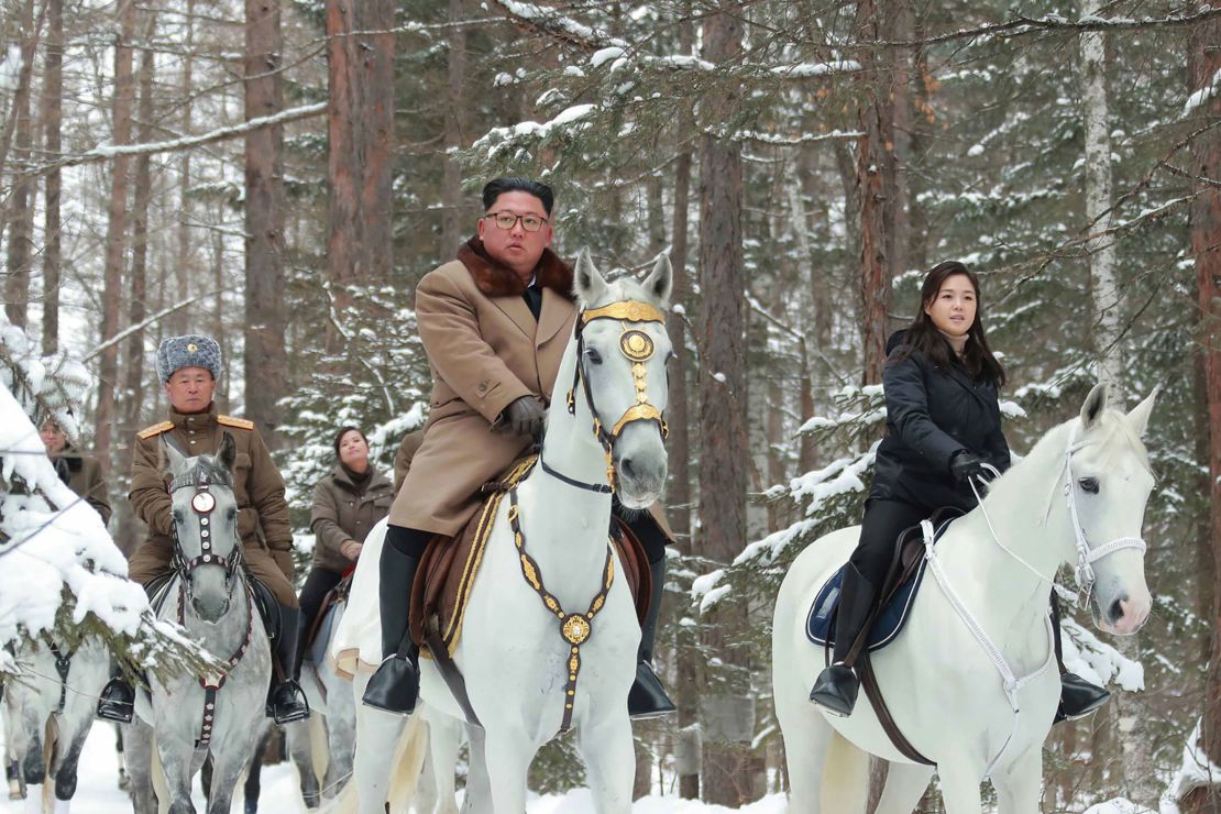 This undated photo released by North Korea's official Korean Central News Agency Wednesday shows North Korean leader Kim Jong Un (center), his wife Ri Sol Ju (right, in black) and Pak Jong Chon (left, in the grey hat) visiting Mount Paketu. 