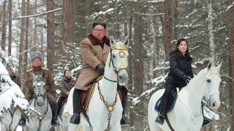 This undated photo released by North Korea's official Korean Central News Agency Wednesday shows North Korean leader Kim Jong Un (center), his wife Ri Sol Ju (right, in black) and Pak Jong Chon (left, in the grey hat) visiting Mount Paketu. 