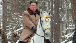 This undated picture released from North Korea's official Korean Central News Agency (KCNA) on December 4, 2019 shows North Korean leader Kim Jong Un (C) riding a horse as he visits battle sites at Mount Paektu, Ryanggang.