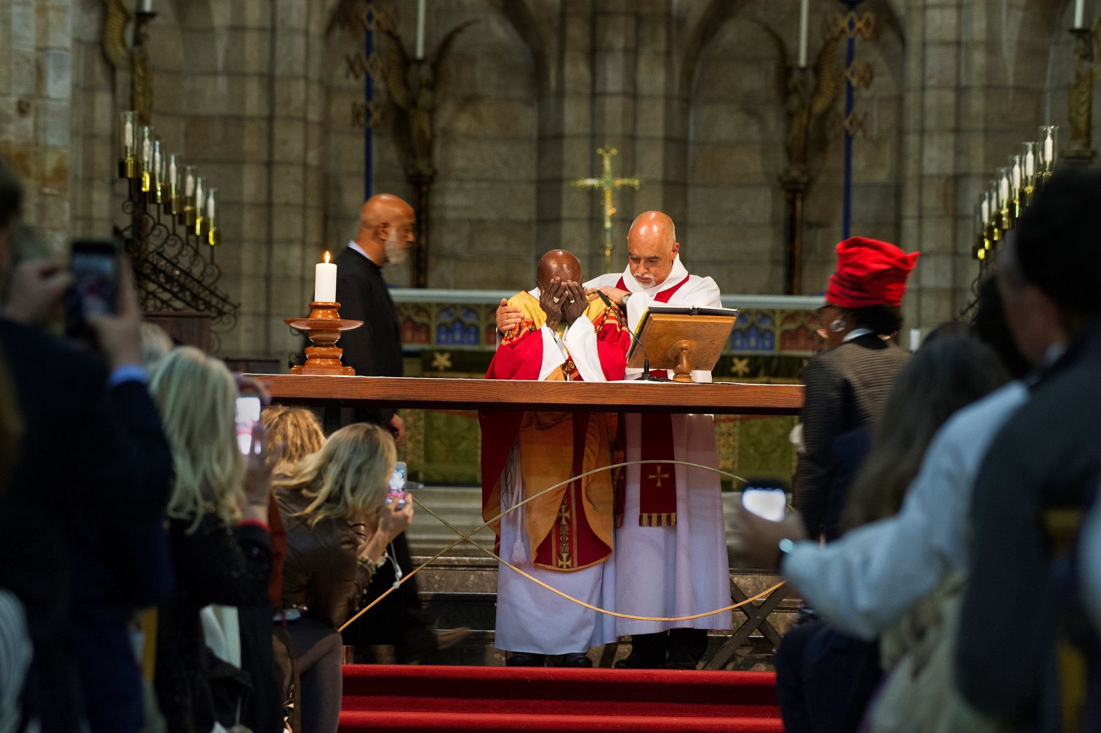 Tutu is comforted by Dean Michael Weeder as he cries during a Mass to mark his 85th birthday in 2016.