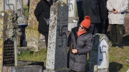 People look at vandalised tombs, on December 4, 2019 at the jewish Westhoffen cemetery near Strasbourg, eastern France, where 107 graves were found vandalised with swastikas and antisemitic inscriptions. (Photo by Patrick HERTZOG / AFP) (Photo by PATRICK HERTZOG/AFP via Getty Images)
