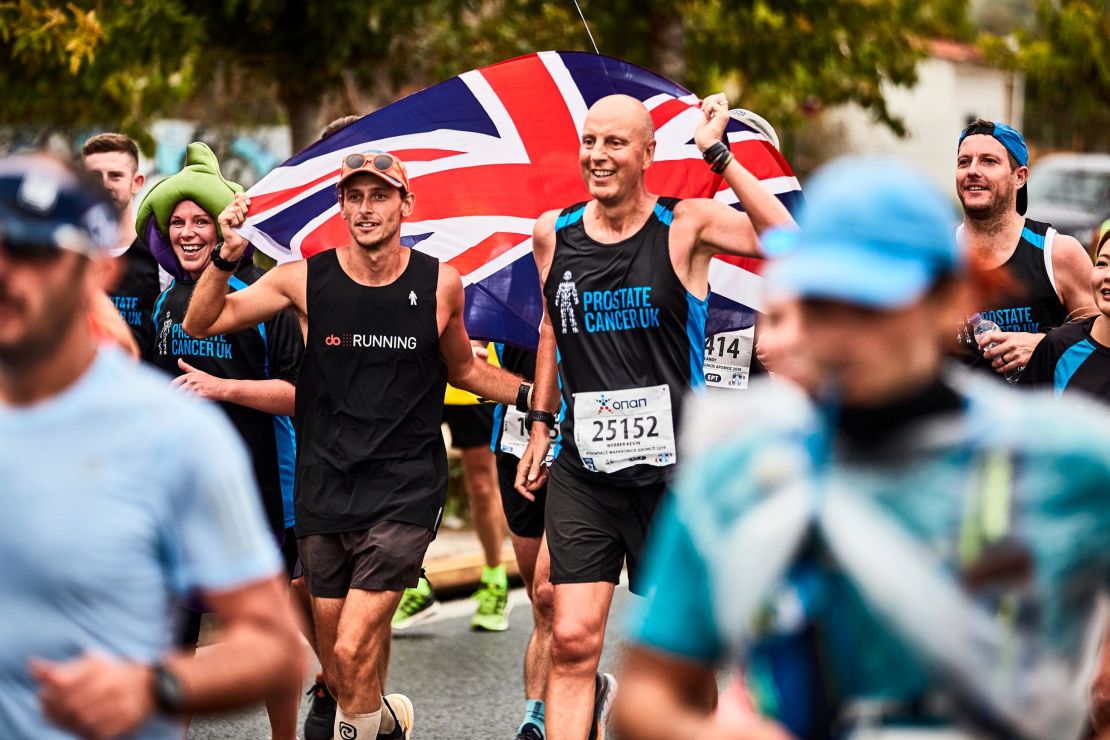 Butter runs with his friend Kevin Webber at the Athens Marathon in November.