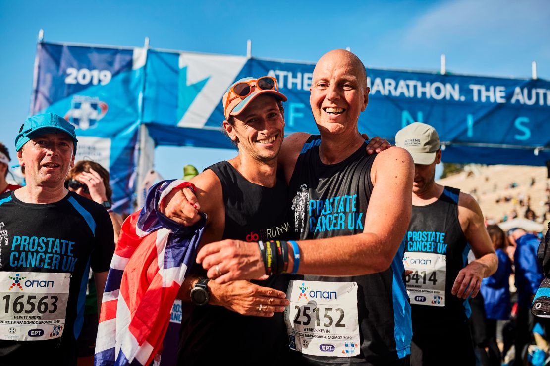 Butter (left) celebrates at the finish line in Athens with close friend Kevin Webber -- the inspiration behind the trip. 