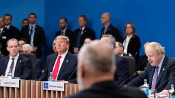 Britain's Foreign Secretary Dominic Raab (L) and US President Donald Trump (2L) listen as Britain's Prime Minister Boris Johnson (R) speaks during the plenary session of the NATO summit at the Grove hotel in Watford, northeast of London on December 4, 2019. 