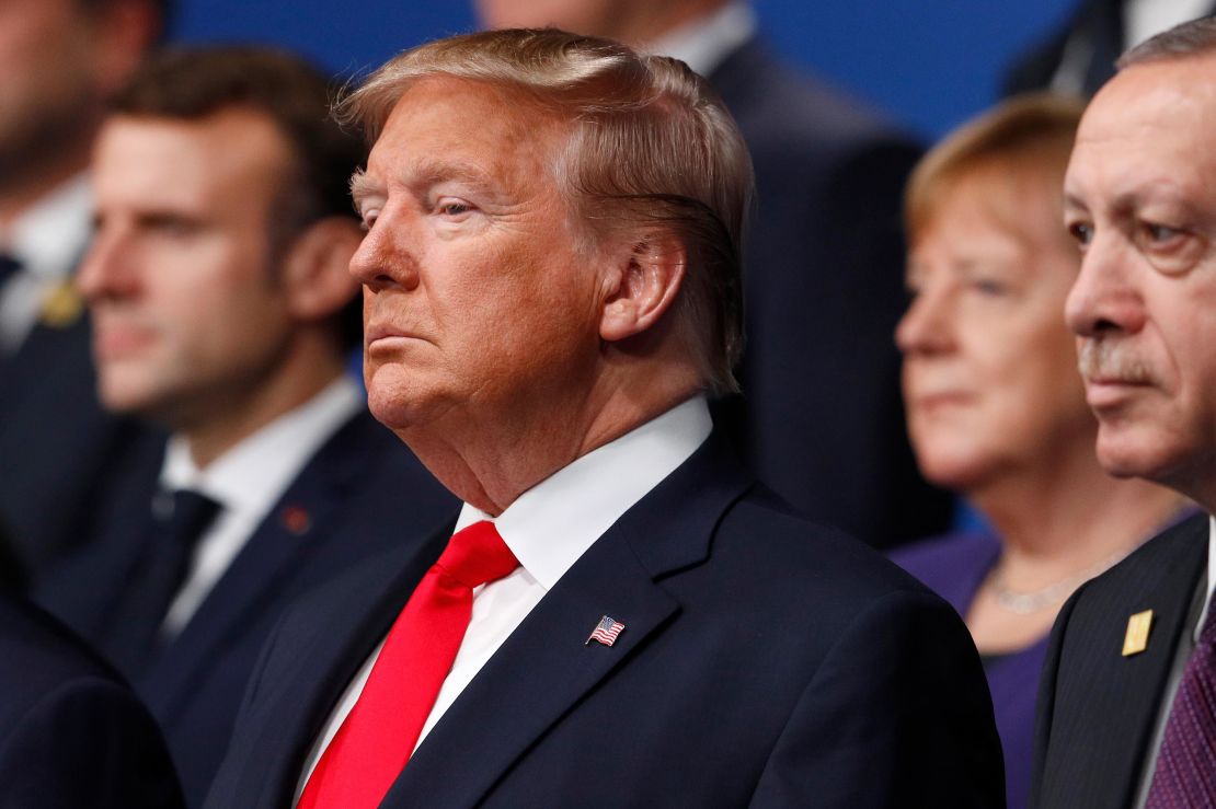 From left, French President Emmanuel Macron, US President Donald Trump, German Chancellor Angela Merkel and Turkish President Recep Tayyip Erdogan pose during a group photo for a NATO leaders meeting at The Grove hotel and resort in Watford, Hertfordshire, England, Wednesday, December 4.