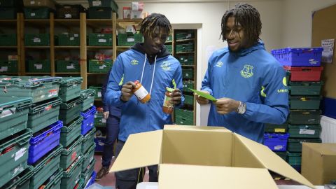 Moise Kean and Alex Iwobi help sort stock at North Liverpool food bank.