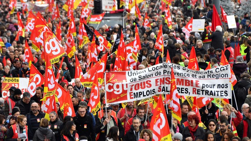 People wave the flags of French trade union General Confederation of Labour (CGT) as they take part in a demonstration to protest against the pension overhauls, in Marseille, southern France, on December 5, 2019 as part of a national general strike. - Trains cancelled, schools closed: France scrambled to make contingency plans on for a huge strike against pension overhauls that poses one of the biggest challenges yet to French President's sweeping reform drive. (Photo by CLEMENT MAHOUDEAU / AFP) (Photo by CLEMENT MAHOUDEAU/AFP via Getty Images)