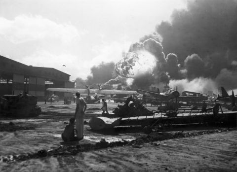 Airmen at Hickam Field watch as bombs explode. The Hickam Field airbase was heavily targeted during the attack, and Japanese bombers sought to prevent counter-attacks from US forces by disabling American planes on the ground.