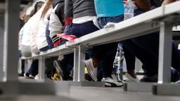 Migrants who are applying for asylum in the United States go through a processing area at a new tent courtroom at the Migration Protection Protocols Immigration Hearing Facility, Tuesday, Sept. 17, 2019, in Laredo, Texas.