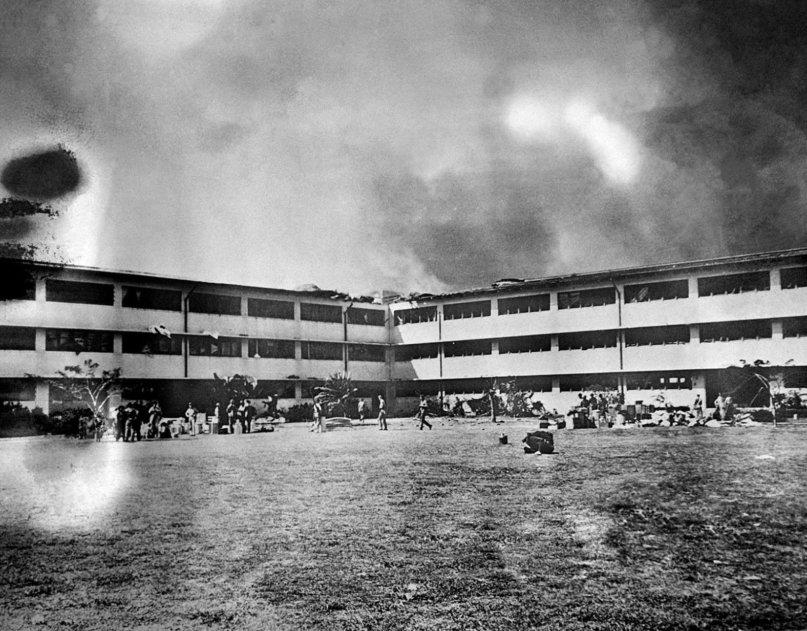 A fire spreads through the Army barracks at Hickam Field.