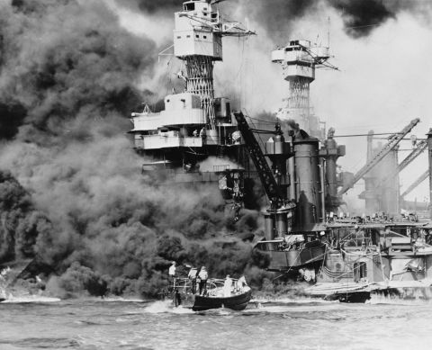 A rescue boat retrieves a seaman from the burning USS West Virginia after the Japanese attacked Pearl Harbor on December 7, 1941.