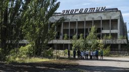 PRIPYAT, UKRAINE - JULY 2: Tourists are guided around the abandoned city of Pripyat, inside the Chernobyl Exclusion Zone, on July 2, 2019 in Pripyat, Ukraine. In November 2016, the 'New Safe Confinement' structure was shifted into place to prevent the decaying reactor from further contaminating the environment and eventually allow its dismantling; the Ukrainian government will soon be taking control of the new confinement structure. The power station's reactor number four exploded in April 1986, showering radiation over the local area, nearby regions of Belarus, and other portions of Europe. (Photo by Brendan Hoffman/Getty Images)