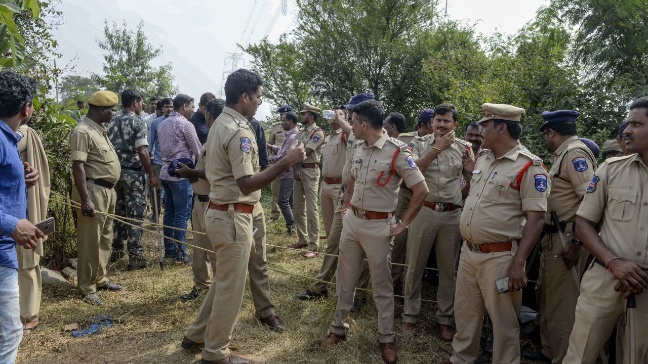 Police personnel stand near the site where they shot dead four detained gang-rape and murder suspects as they were re-enacting their alleged crime, in Hyderabad. 