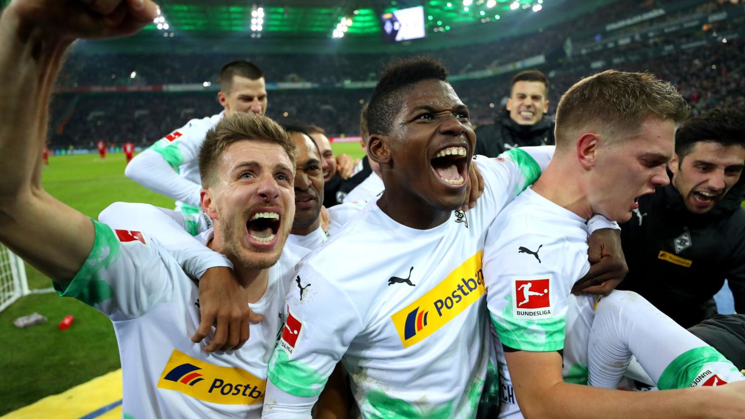 Borussia Monchengladbach players celebrate victory against Bayern Munich.
