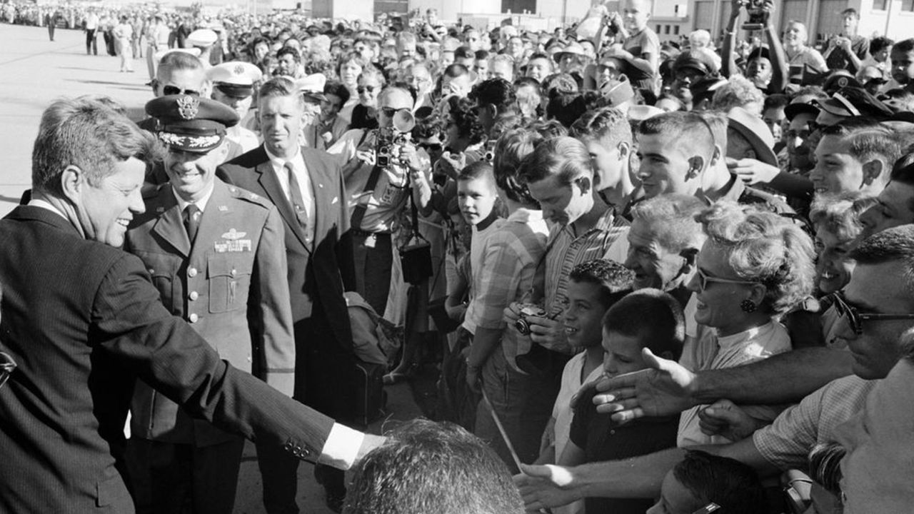 President John F. Kennedy greets crowds at Castle Air Force Base in California in August 1962. Secret Service agent Winston Lawson stands behind the left shoulder of  Brig. Gen. William R. Yancey.