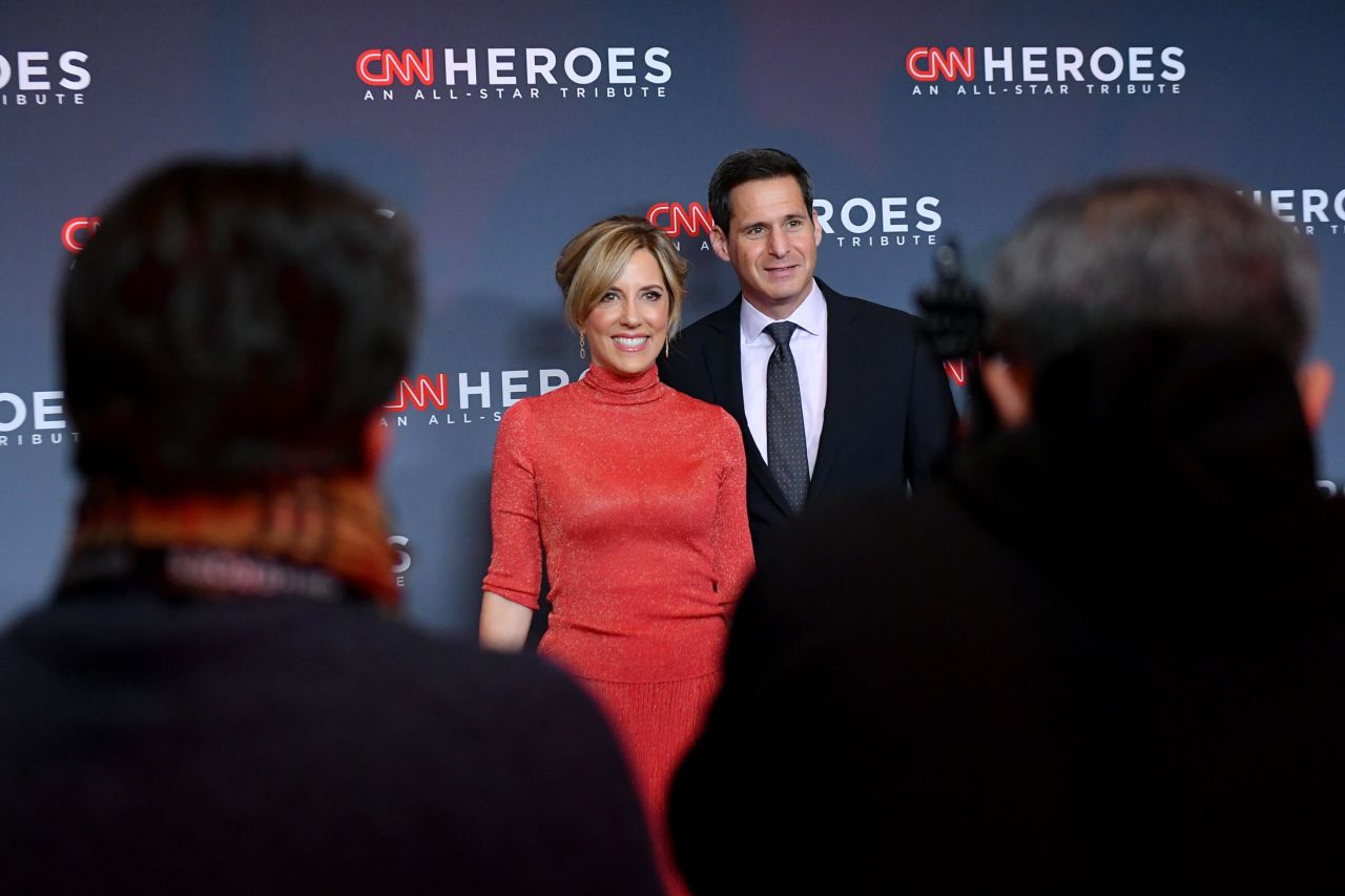 CNN anchors John Berman and Alisyn Camerota pose for photographers.