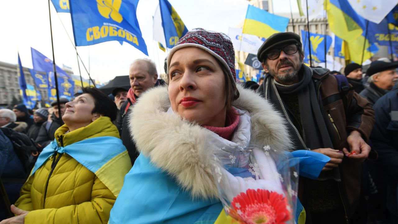 Protesters draped in Ukrainian flags rally against Zelensky's Donbas peace plan.