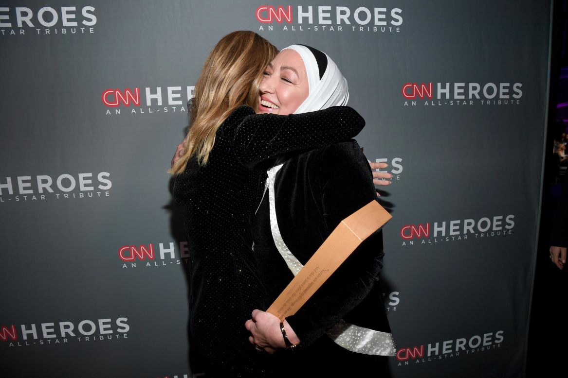 Top 10 CNN Hero Najah Bazzy embraces host Kelly Ripa backstage after accepting her award. Bazzy runs Zaman International, a nonprofit that now supports impoverished women and children of all backgrounds in the Detroit area. Today, Zaman runs a 40,000-square-foot facility in the Detroit suburb of Inkster, and the group has helped provide more than 250,000 people with food, clothes and furniture free of charge.