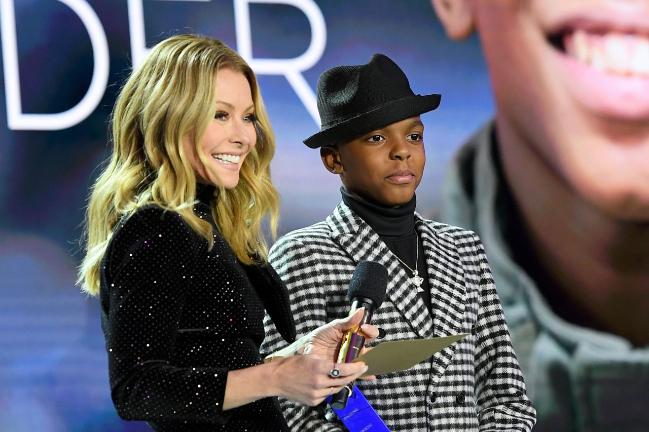 Host Kelly Ripa presents 2019 Young Wonder Jahkil Jackson with his award onstage. When Jackson was just 8 years old, he started Project I Am. He and his nonprofit create and distribute bags filled with hygiene products and other necessary items to help people in their daily lives.